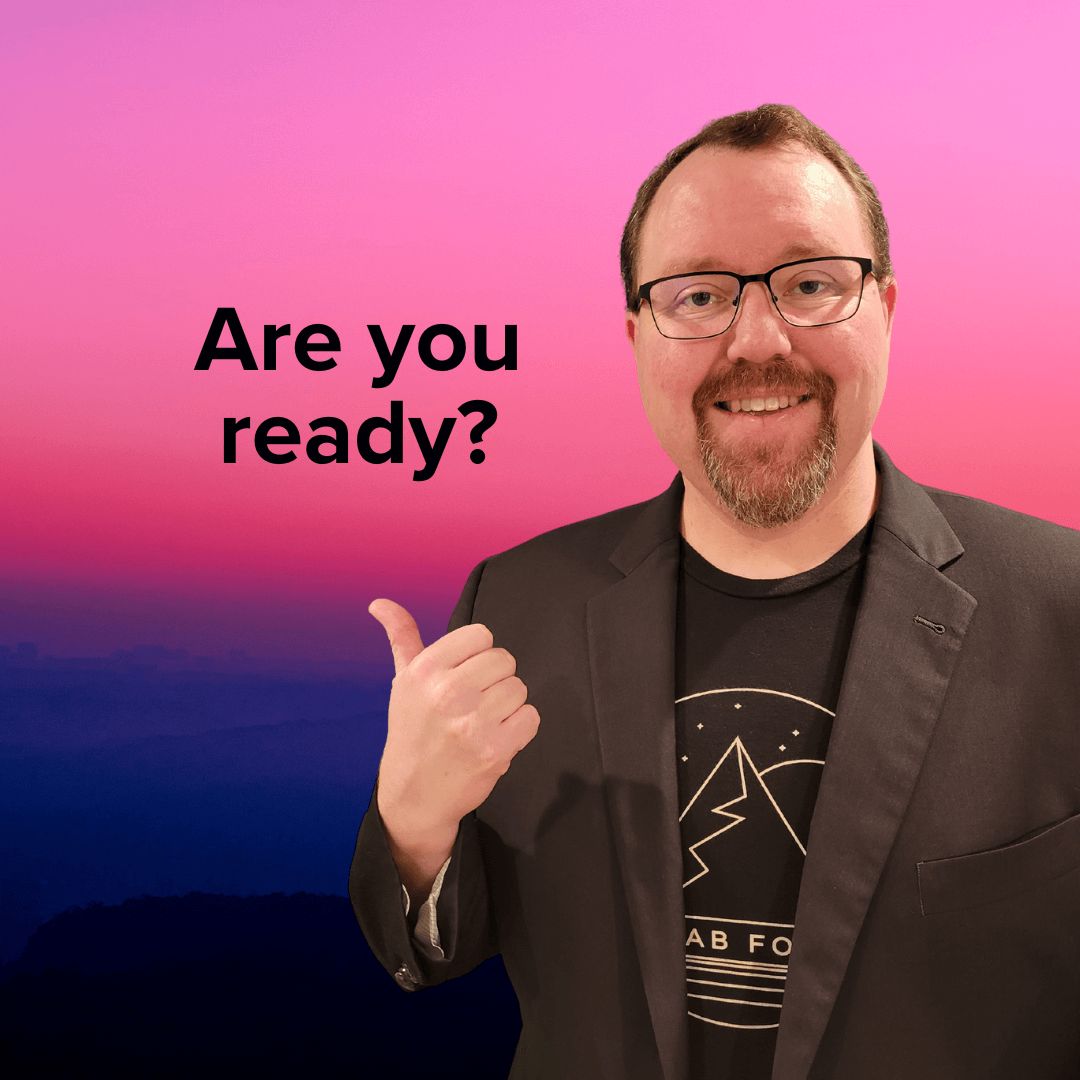 Photo of Kevin Estes wearing a suit and tee shirt. His right thumb is up and points to 'Are you ready?' The background is from the top of a mountain at sunset.