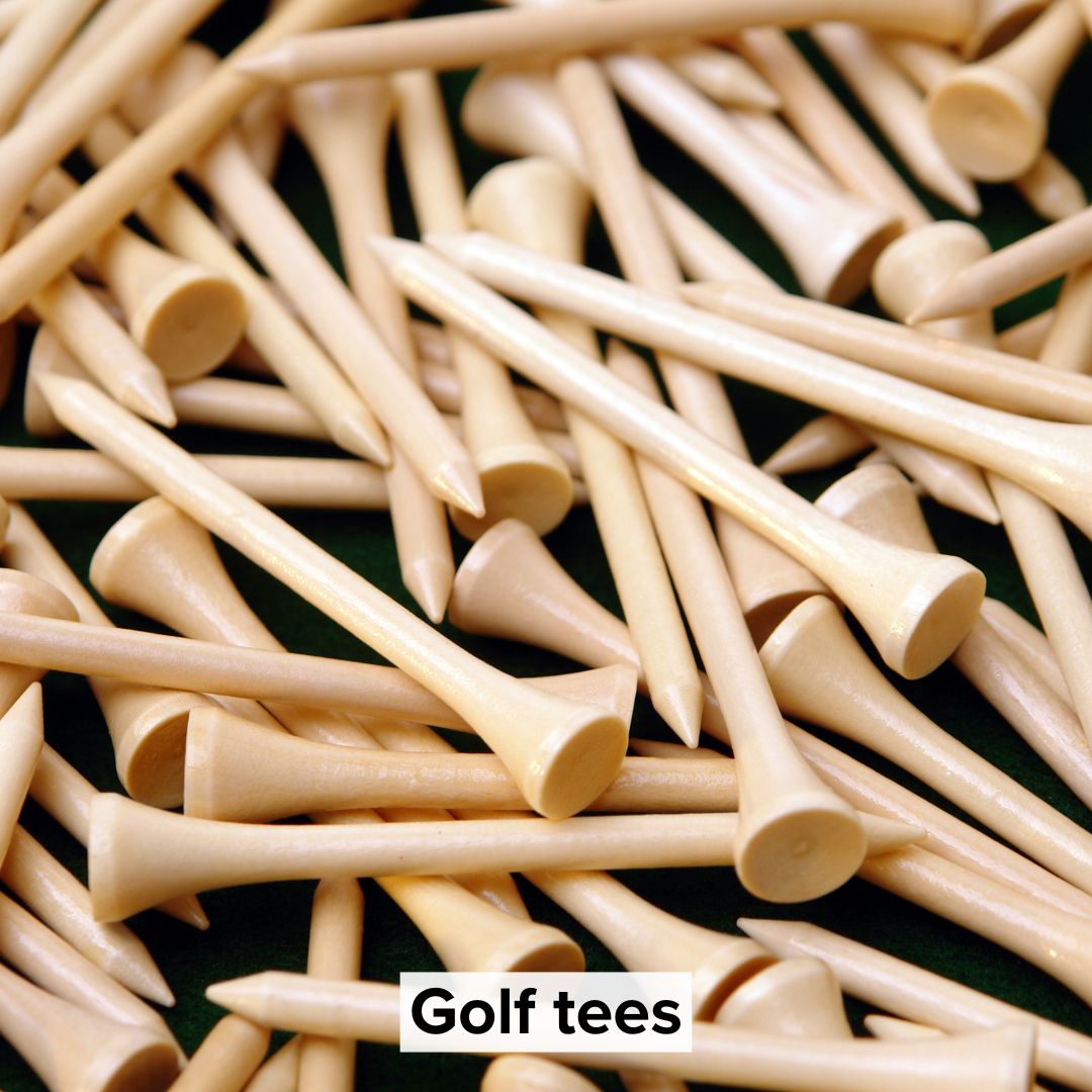 Title 'Golf tees' in black surrounded by a light background toward the bottom. The image is of dozens of golf tees on a dark background.