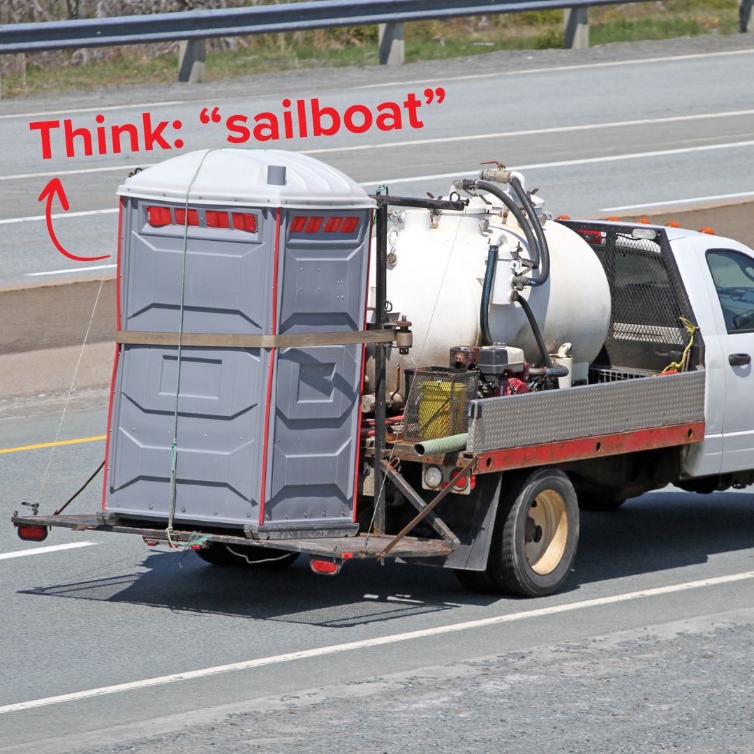 Title Think: 'sailboat' in red on top. The image is of a truck with a pump out tank carrying a porta potty on the back while driving down a divided highway.